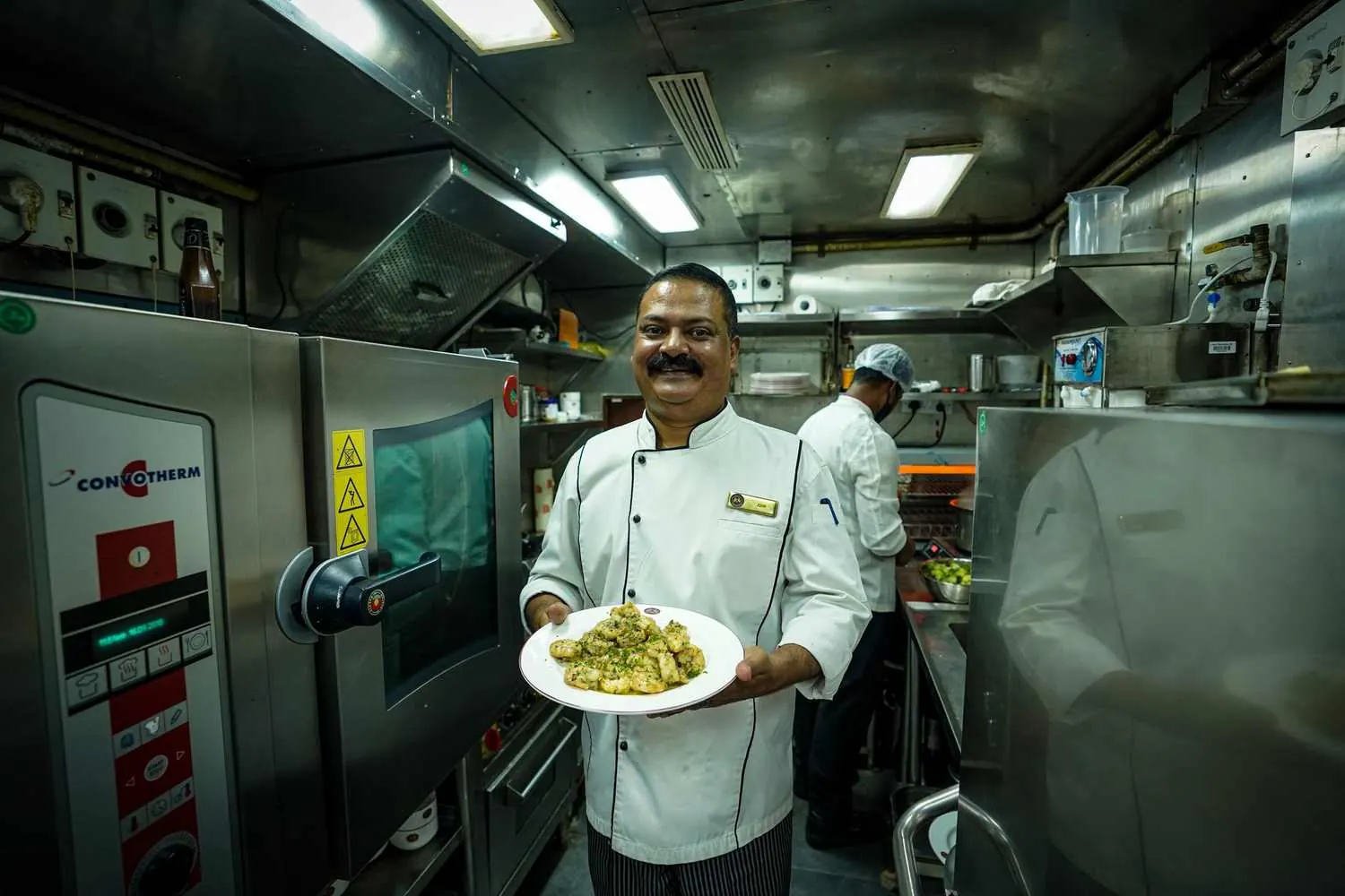 Golden Chariot chef in the onboard kitchen